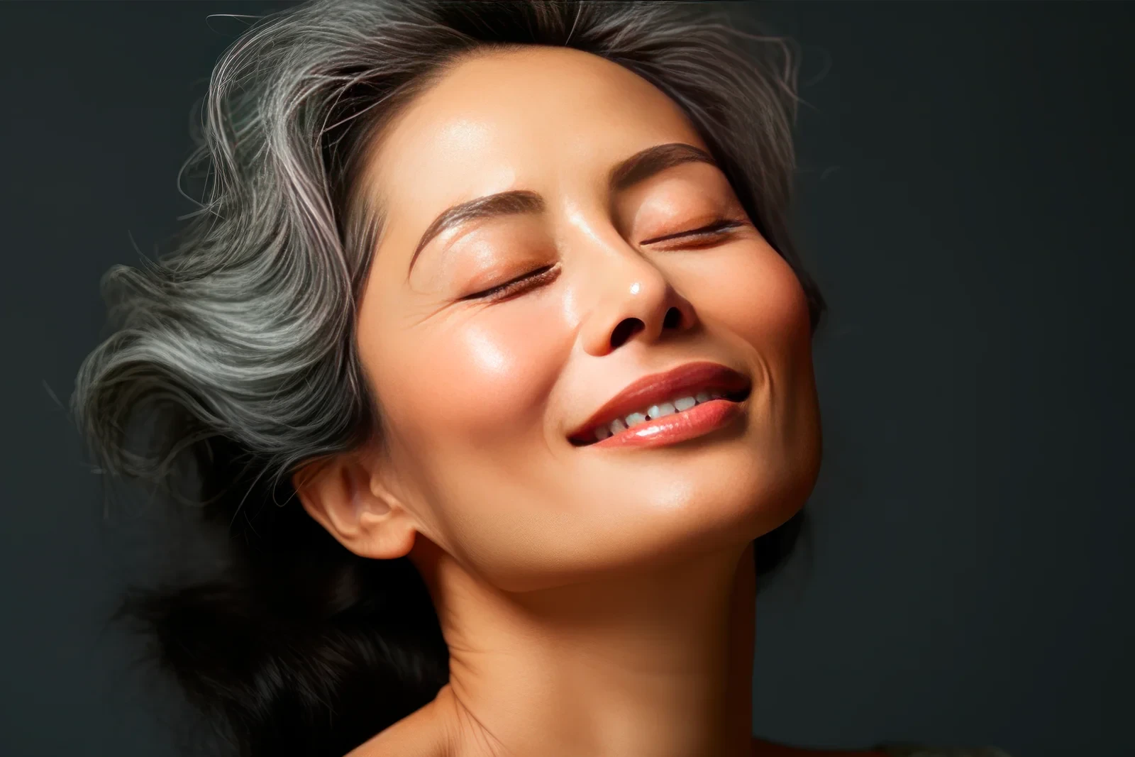 Woman with healthy, glowing skin representing youthfulness after peptide therapy.