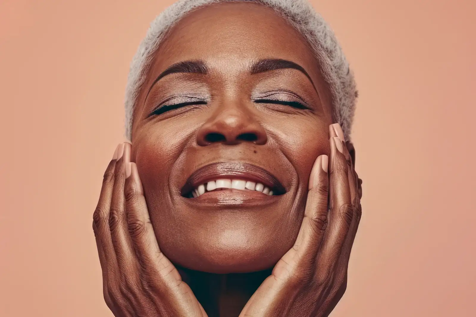 Woman with healthy, smiling face, benefiting from the anti-aging effects of peptide therapy.