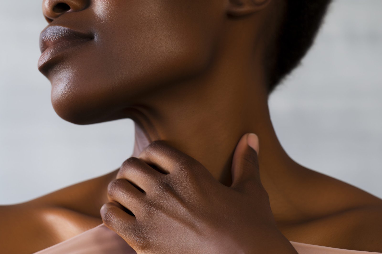 Woman touching a defined jawline after double chin reduction Seychelles